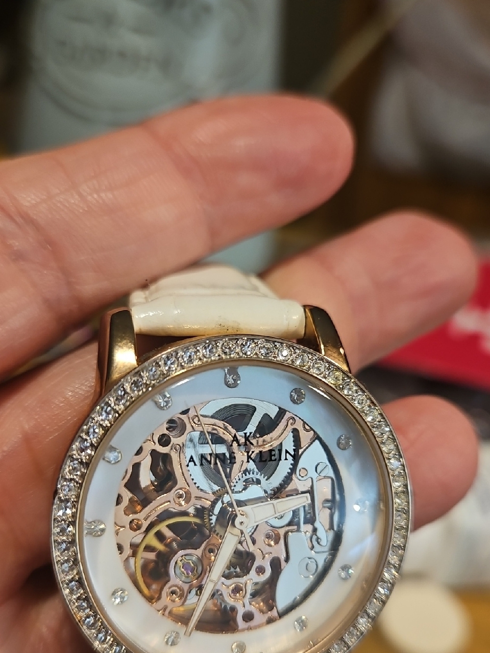 Anne Klein Gold-Tone Crystal Bezel Skeleton Watch with White Strap